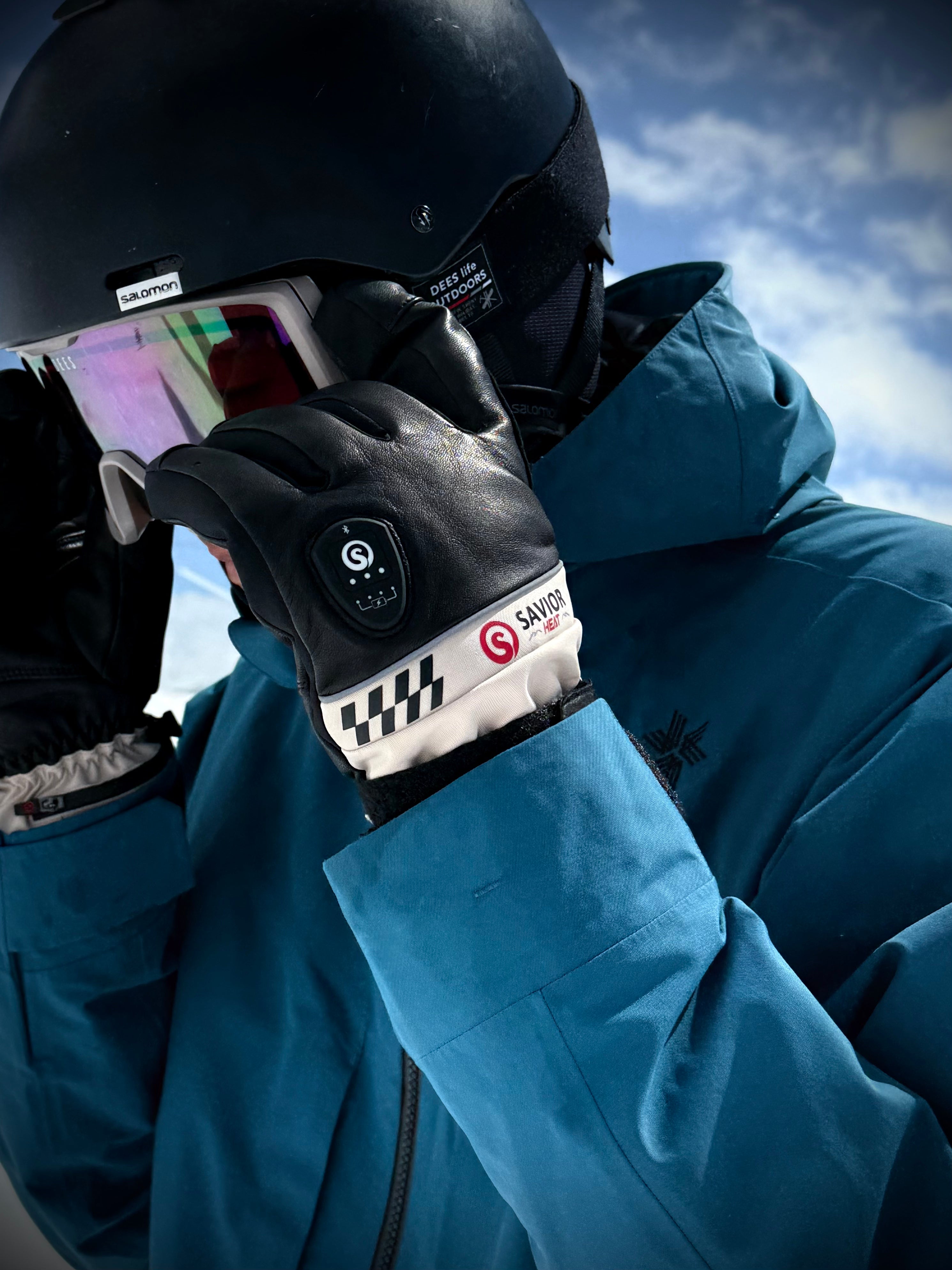 Skier using SAVIOR battery heated gloves on mountain