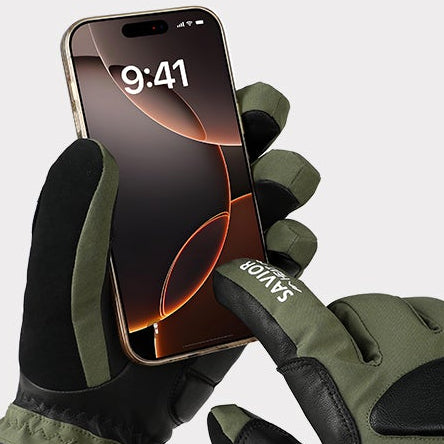 Touchscreen-compatible heated gloves in green and black operating a smartphone, ideal for winter sports, cycling, and cold-weather outdoor use.