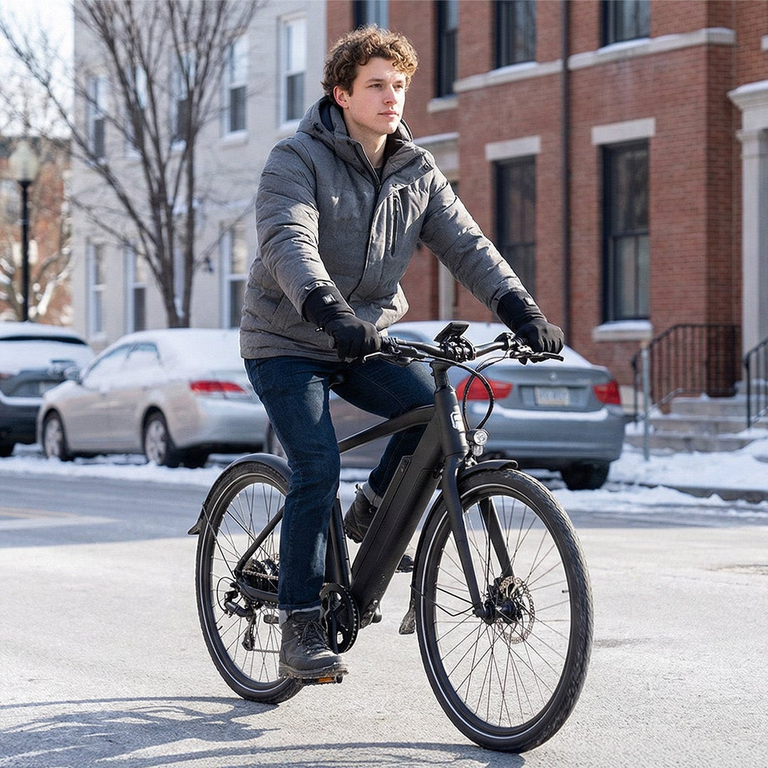 Man riding e-bike in winter city wearing wholesale heated gloves from professional heated gloves manufacturer