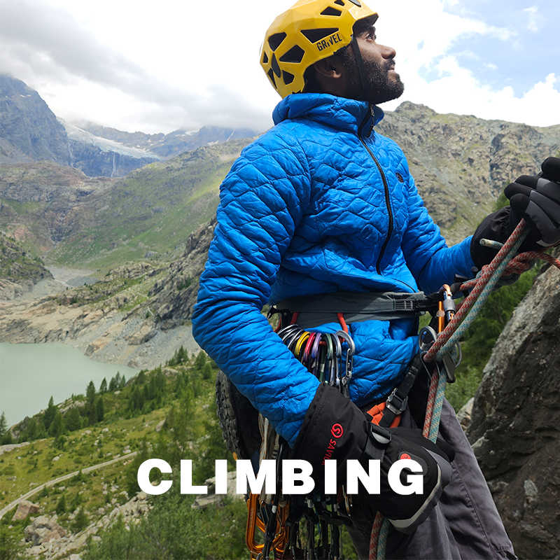 Climber wearing Savior Heat heated gloves while mountaineering; provides warmth, grip and safety in cold outdoor climbing conditions.