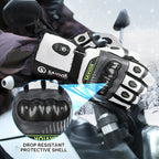 Heated motorcycle gloves with a protective shell, worn while riding in snowy weather.