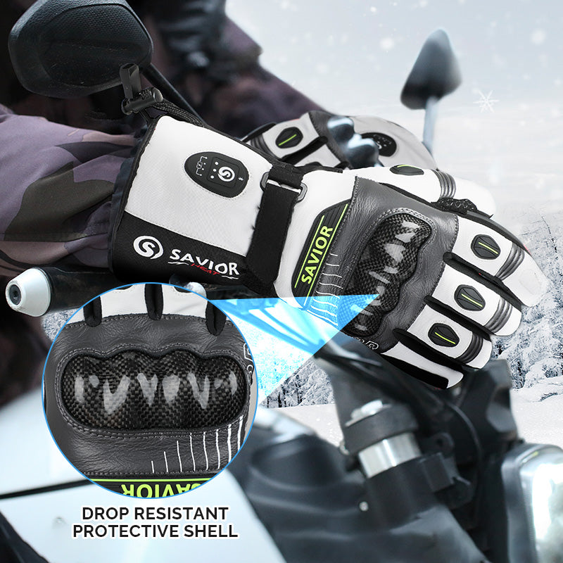 Heated motorcycle gloves with a protective shell, worn while riding in snowy weather.