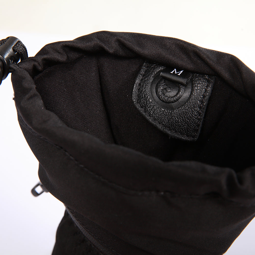Soft inner cuff of black winter glove with size tag and leather pull tab, showing inside view of the glove opening.