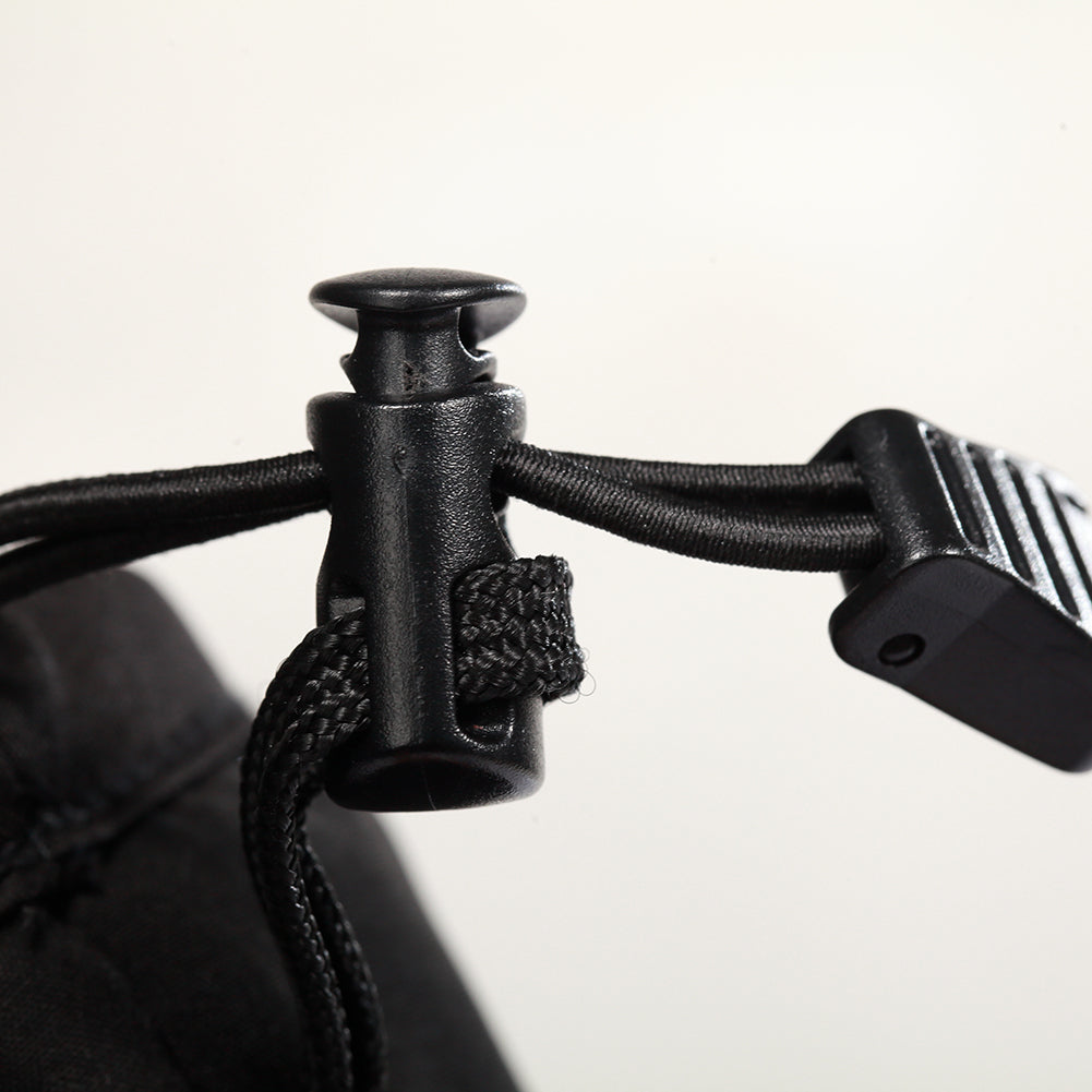 Adjustable drawstring toggle on heated gloves for a secure, windproof fit.