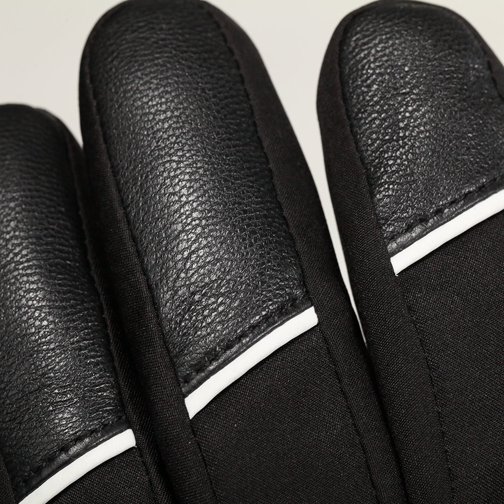 Close-up of reinforced leather fingertip panels on black winter gloves, showing textured grip and durable stitched design.