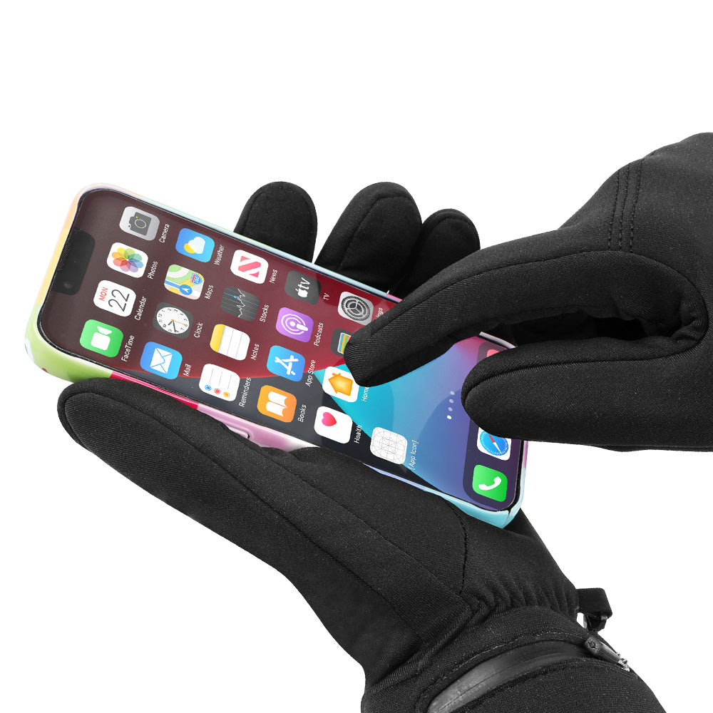 Touchscreen-compatible thin heated gloves operating a smartphone, showing flexible winter glove design for cold-weather use.