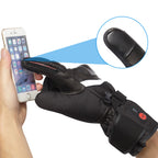 Black heated motorcycle glove using its touchscreen-friendly fingertip to operate a smartphone.