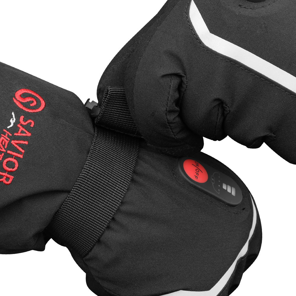 Close-up of black heated gloves showing adjustable wrist strap, reflective trim, and the power button during use.