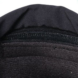 Close-up view of the inner cuff of a black winter glove showing the soft lining and secure Velcro closure.