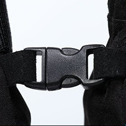 Close-up of a black glove buckle showing durable quick-release design, secure fastening strap, and outdoor glove connection detail.