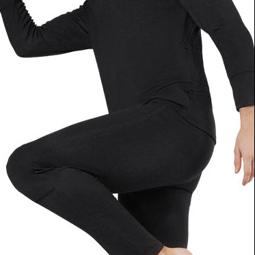 Person wearing black heated underwear, showing flexible, close-fitting design during movement.