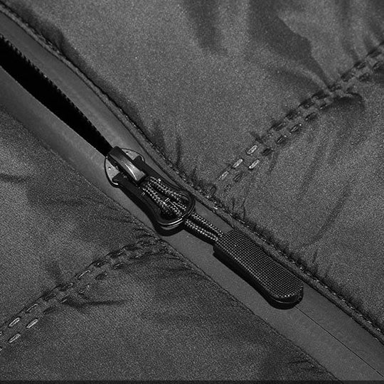 Close-up of black heated vest zipper showing durable stitching and smooth front closure detail.