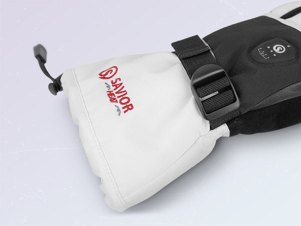 White and black mittens featuring an adjustable wrist strap, elastic cuff, and embroidered brand logo for a secure fit and added warmth