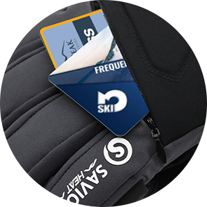 Close-up of a ski glove pocket holding lift passes, showing convenient zipper storage for cards during skiing and winter outdoor sports.