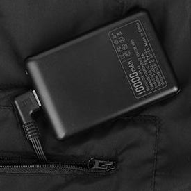 Power bank connected inside black heated vest pocket with zipper closure.