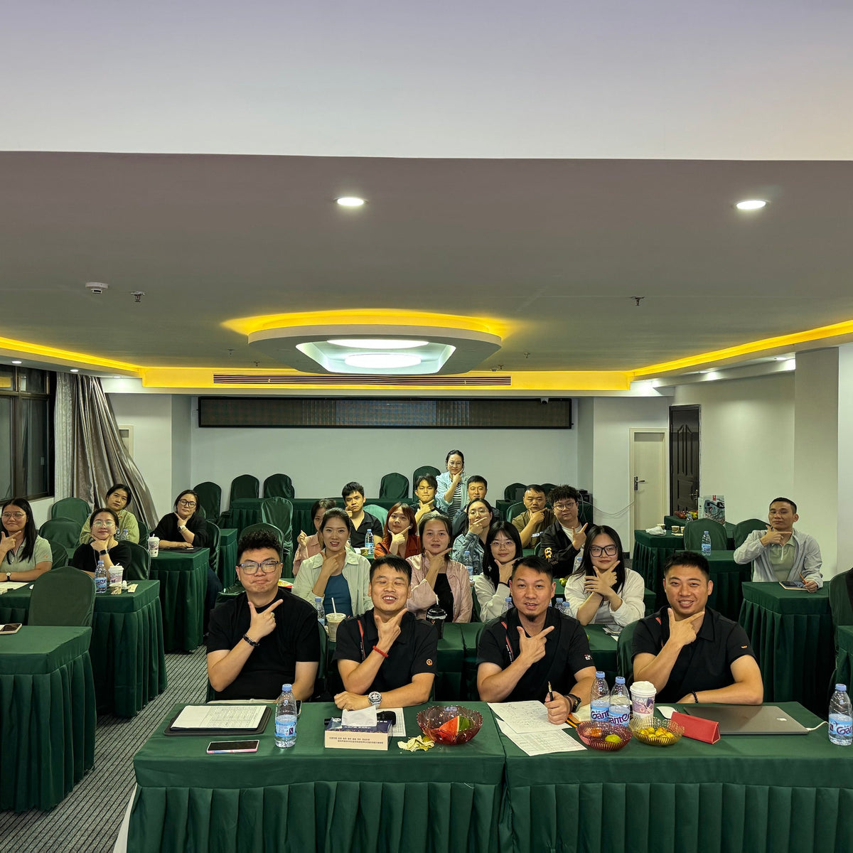 Group photo of a training or workshop session with participants seated in a conference room.